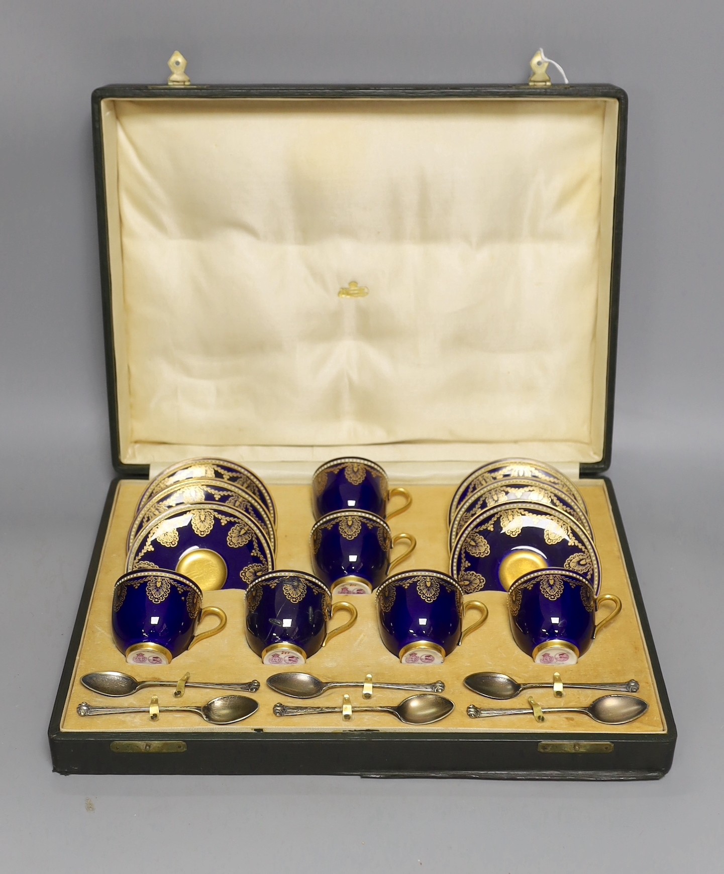 Boxed Royal Worcester blue coffee set with gilt stylised shell and swag design together with six silver coffee spoons; C899 and 6683